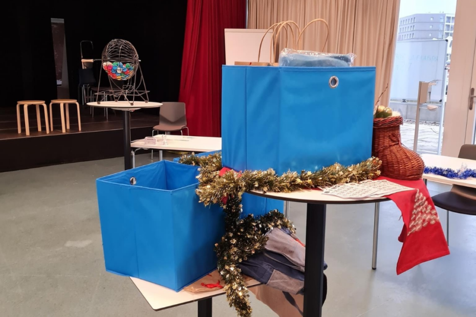 Ein Tisch mit 2 blauen Boxen umgeben von Weihnachtsschmuck